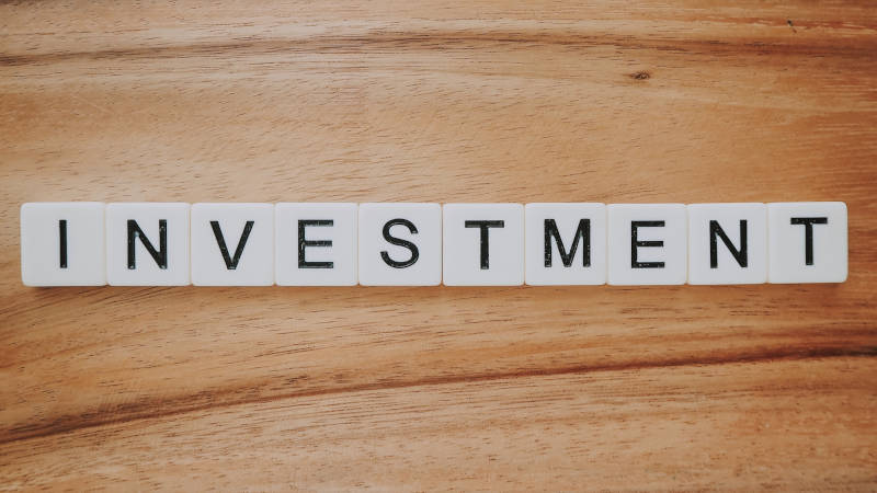 An image showing the word Investment formed out of Scrabble tiles