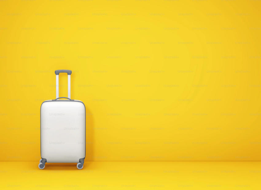 An image showing a silver spinner luggage on a canary yellow background